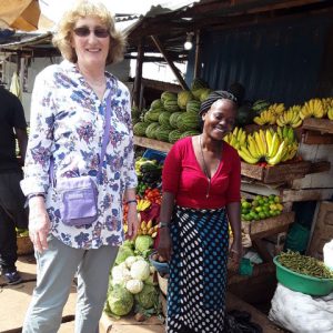 Livvy with Agnes at her stall in Kitoro market doing one of four price check surveys.