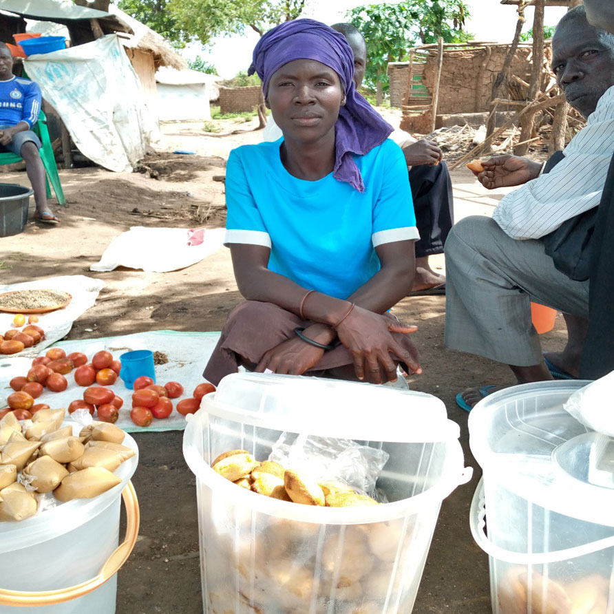 Joyce selling pancakes, G/nut paste and tomatoes in Bulomoni camp