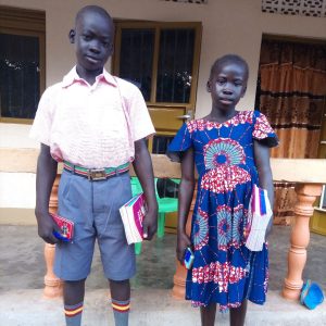 2 of Julious' children with their new school books