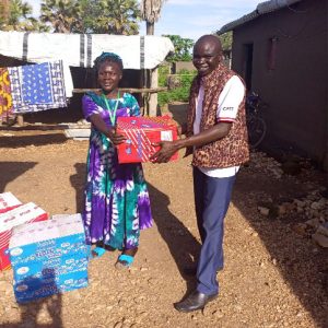 Counsellor Kiden Beatrice of Belameling refugee camp receiving the boxes of donated soap & Biscuit for her traumatized refugees children of Belameling