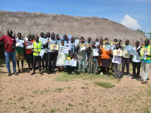 a big group of adults stands facing the camera, holding white A4 certificates