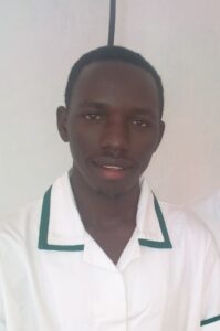 Man in white shirt with green collar smiles at camera