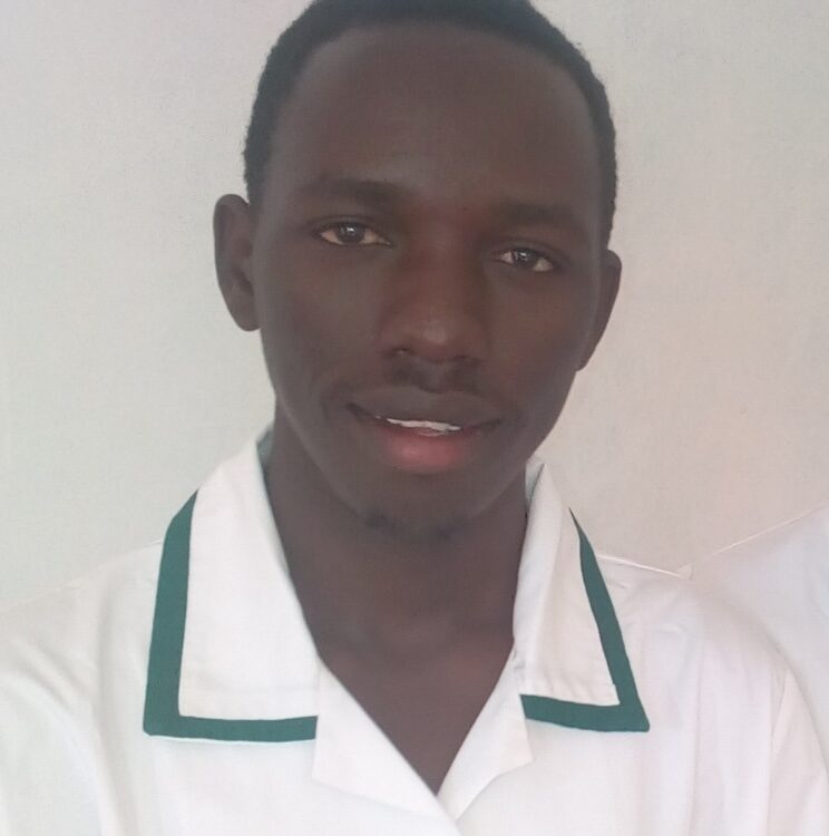Man in white shirt with green collar smiles at camera
